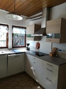 a kitchen with white cabinets and a black counter top at Ferienhaus am Park in Diez