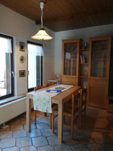 a dining room with a table and chairs at Ferienhaus am Park in Diez