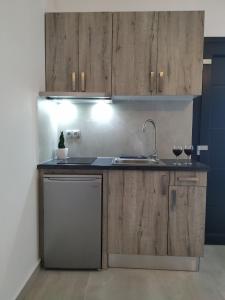 a kitchen with wooden cabinets and a sink at Home Sweet Home in Ammoudia +21 photos
