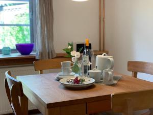 a wooden table with a plate of food on it at Ferienwohnung Suederbootfahrt - Ruheoase für Naturliebhaber in Katingsiel zwischen Tönning und St Peter Ording perfekt für Radtouren in Katingsiel +34 photos