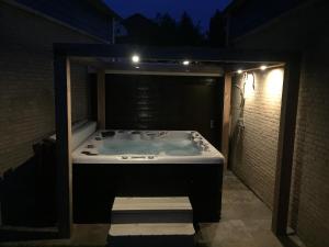 a jacuzzi tub in a building at night at Suite & Wellness in Breskens