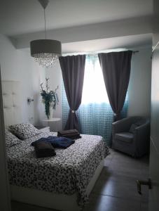 a bedroom with a bed and a chair and a window at APPARTEMENT BONITO VISTAL BRISTOL SUNSET BEACH in Corralejo