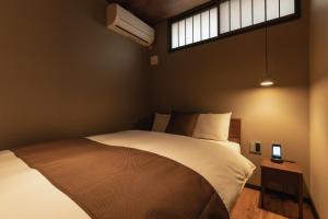 Un pat sau paturi într-o cameră la BEPPU RIKYU