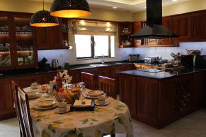 a kitchen with a table with a table cloth on it at Cosy Home in Mellieħa