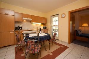 a kitchen and dining room with a table and chairs at Seevilla Nina in Maria Wörth +21 photos