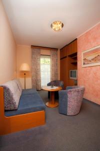 a living room with a couch and a table at Seevilla Nina in Maria Wörth