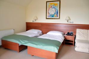 Postel nebo postele na pokoji v ubytování Hotel Mladimir