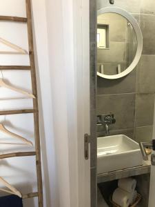 a bathroom with a sink and a mirror at Casas de Mértola - N. Sª das Neves in Mértola
