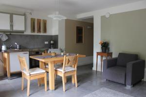 a kitchen with a wooden table and chairs in a kitchen at Kleine Auszeit in Kluis