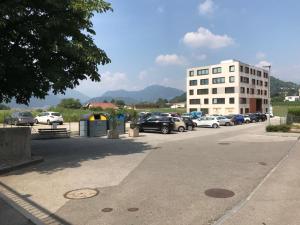a parking lot with cars parked in front of a building at Apartment 33A - No Bikes - Self check-in in Lugano