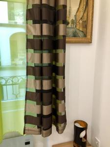 a curtain hanging on a wall next to a window at Buda Boutique Apartment in Budapest +80 photos