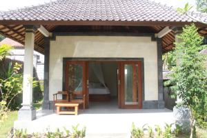 a small house with a bed in the doorway at Rumah Sidemen in Sidemen +6 photos
