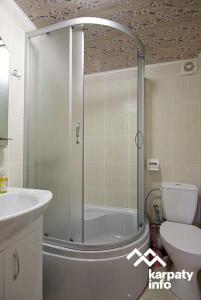 a bathroom with a shower with a toilet and a sink at микуличин на долоні in Mykulychyn