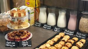 a display case with different types of pastries and milk at Hotel Plaza in Pag