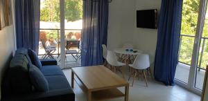 a living room with a couch and a table at Apartamenty Aqua in Pobierowo