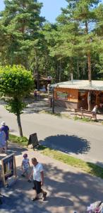 a man and two children walking in a park at Apartamenty Aqua in Pobierowo