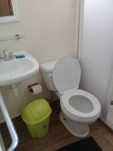 a bathroom with a white toilet and a sink at HOTEL PARAISO ACAPULCO in Acapulco +28 photos