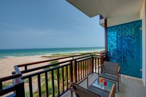 a balcony with a view of the beach at Crowne Plaza Duqm, an IHG Hotel in Duqm