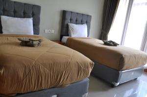 Postel nebo postele na pokoji v ubytování Hastina Hotel Lombok