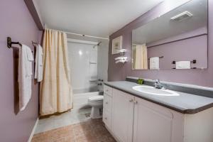 a bathroom with a sink and a toilet at Long Sault Motel in Long Sault