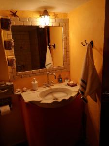 a bathroom with a sink and a mirror at Glaros in Pera Gyalos