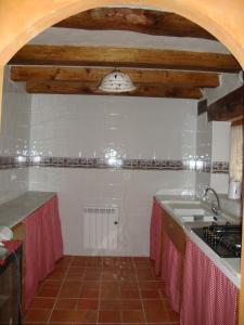 a kitchen with a sink and a counter top at O´Porron in Sabiñánigo
