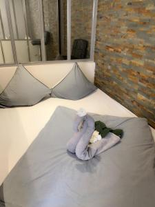 a towel animal sitting on top of a bed at Appartement Design Centre ville in Saint-Tropez