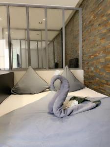 a swan made out of towels on a bed at Appartement Design Centre ville in Saint-Tropez