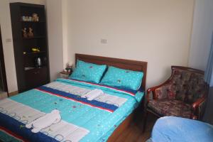 a bedroom with a bed and a chair at Seek Place in Tainan