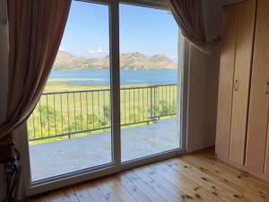 a room with a large window with a view of the ocean at Skadar lake house Bobija in Podgorica