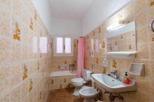 a bathroom with a toilet and a sink at Villa Maria Makri in Paleokastritsa
