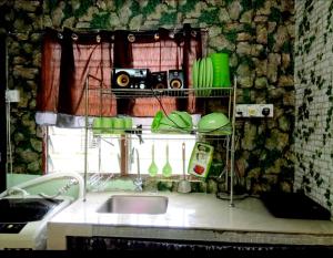 a kitchen with a sink and a shelf with a camera at 2 BR Medina Dollar Landed Homestay Cheras MRT Link in Cheras +8 photos
