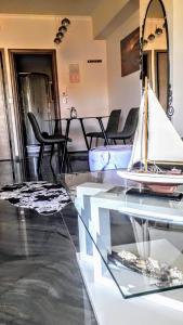 a living room with a glass table and chairs at Tony Central Luxury Apartment 1 in Chania Town