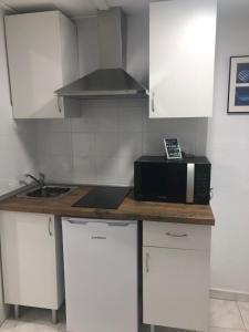 Kuchyň nebo kuchyňský kout v ubytování Apartamento City & Beach
