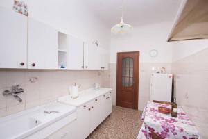 a white kitchen with a sink and a refrigerator at Easylife in Rome
