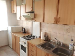 a kitchen with a sink and a stove top oven at Mieszkanie 3-pokojowe Gdańsk, ul. Rybna (2/4 piętro) in Gdańsk