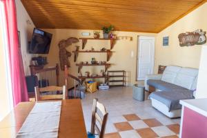 a living room with a table and a couch at Attic Anemoessa in Alexandroupoli