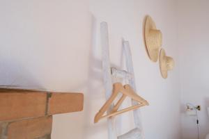 a pair of wooden hangers hanging on a wall at Casas de Mértola 32 in Mértola