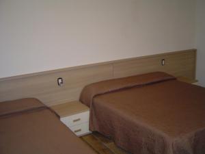 two beds in a hotel room with two beds at Irene in Pistoia