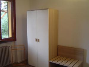 a white cabinet in a room with a window at Irene in Pistoia