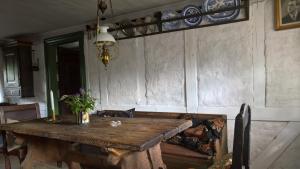 a wooden table and a couch in a room at Thurup Hus in Assens