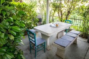 a table and two chairs and a table and a bench at Apartments Bukovšek in Portorož