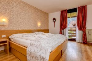 Voodi või voodid majutusasutuse Bepy Hotel Garni toas