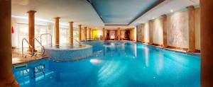 a large swimming pool with a tub in the middle at Nailcote Hall in Berkswell