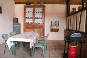Il comprend une cuisine équipée d'une table, de chaises et d'une cuisinière. dans l'établissement A l'Ancienne Ferme, à Sarre-Union