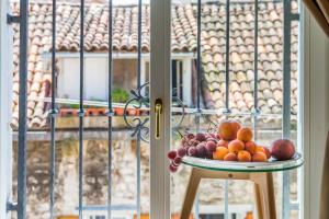 a bowl of fruit on a table in front of a window at Princ Heritage Rooms in Split