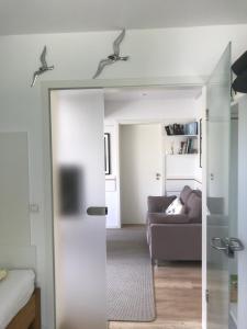 a living room with a couch and a mirror at Kajüte Holtenau in Kiel +30 photos