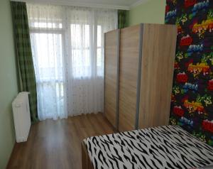 a room with a bed and a cabinet in it at Legyél a vendégünk :) in Debrecen