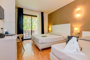 Postel nebo postele na pokoji v ubytování Hotel Riel + 37 fotografií