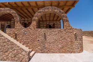 a large stone wall with arches on a building at Casa Zita Lampedusa in Lampedusa